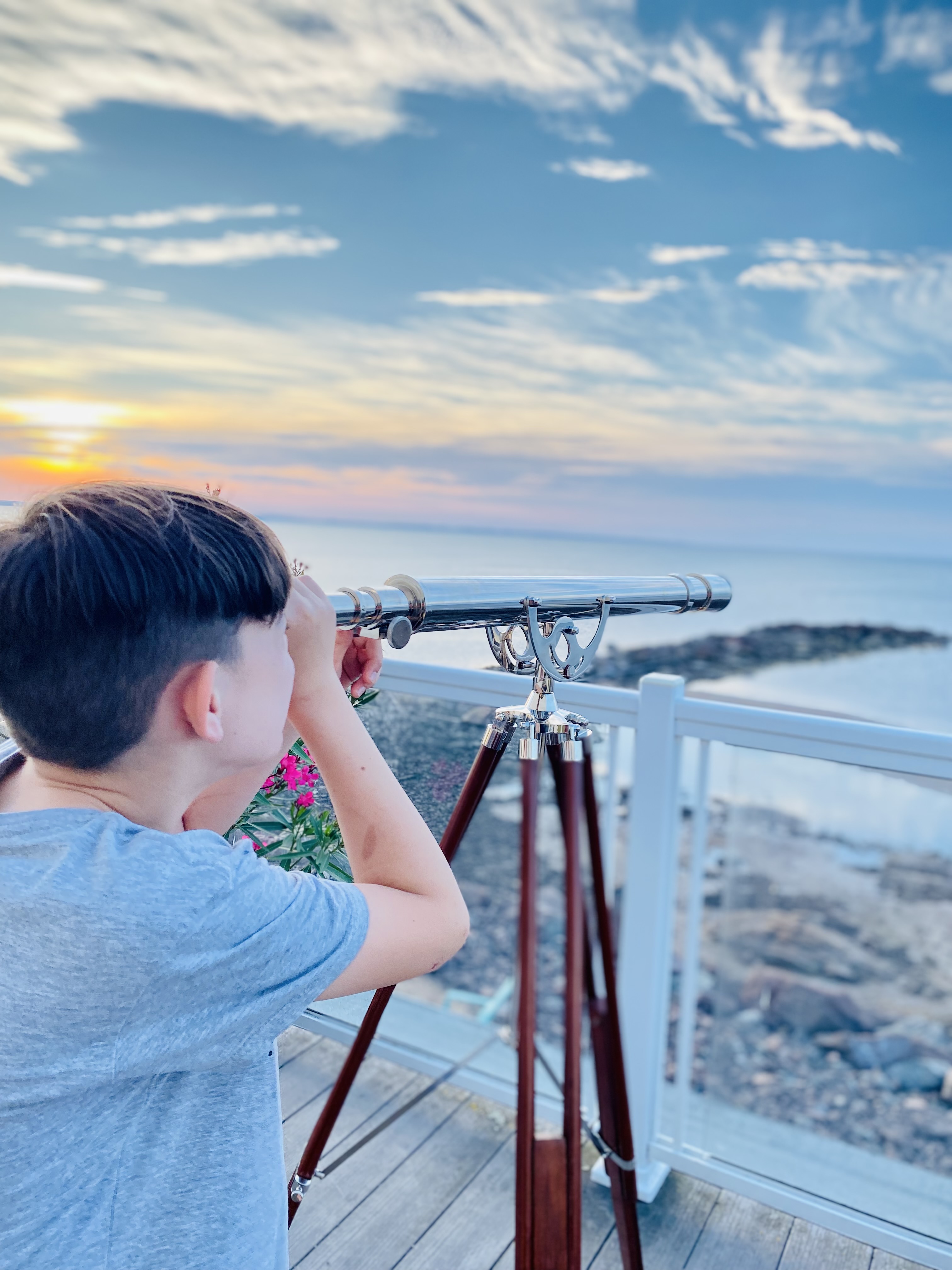 Boy with telescope looking out