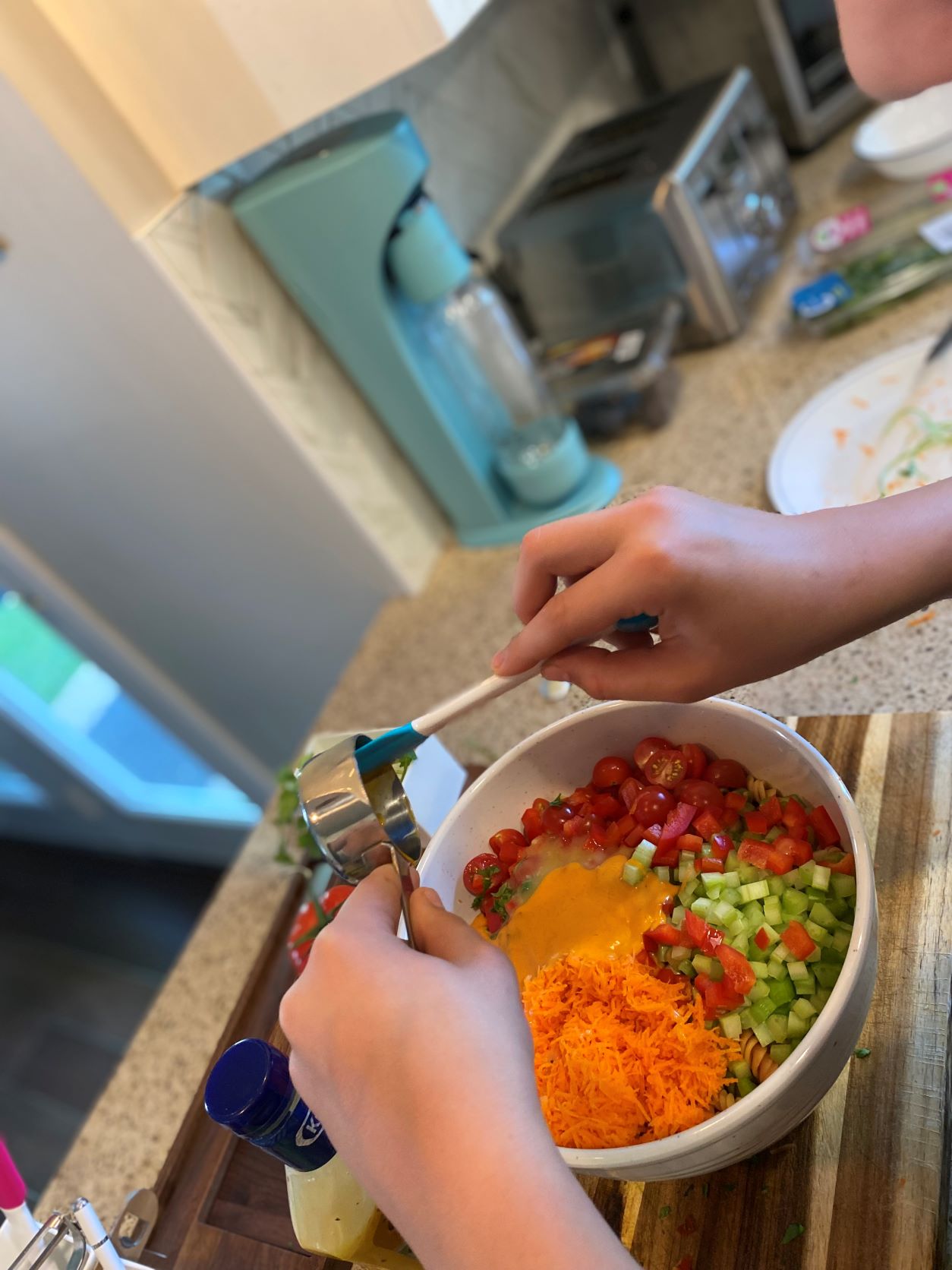 mixing sauce for pasta salad